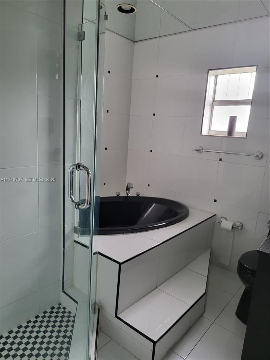 6771 Northwest 199th Terrace Hialeah, FL 33015 - Photo 19 of 42 a utility room with cabinets and a window