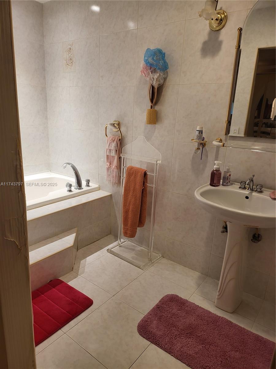 6771 Northwest 199th Terrace Hialeah, FL 33015 - Photo 21 of 42 a bathroom with a sink and a mirror
