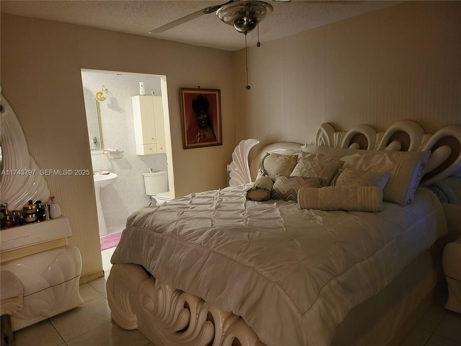 6771 Northwest 199th Terrace Hialeah, FL 33015 - Photo 22 of 42 a bedroom with a bed and a chandelier