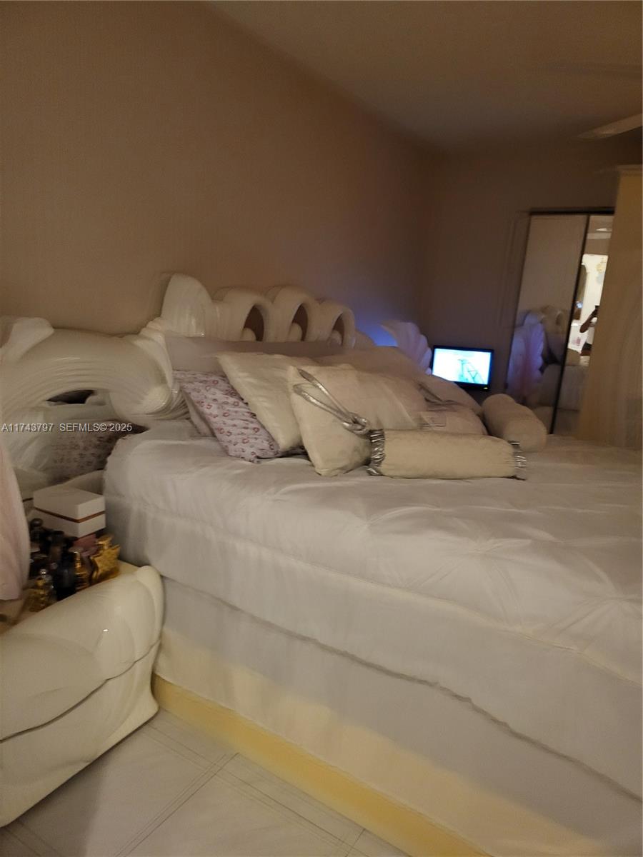 6771 Northwest 199th Terrace Hialeah, FL 33015 - Photo 23 of 42 a bedroom with a bed and window