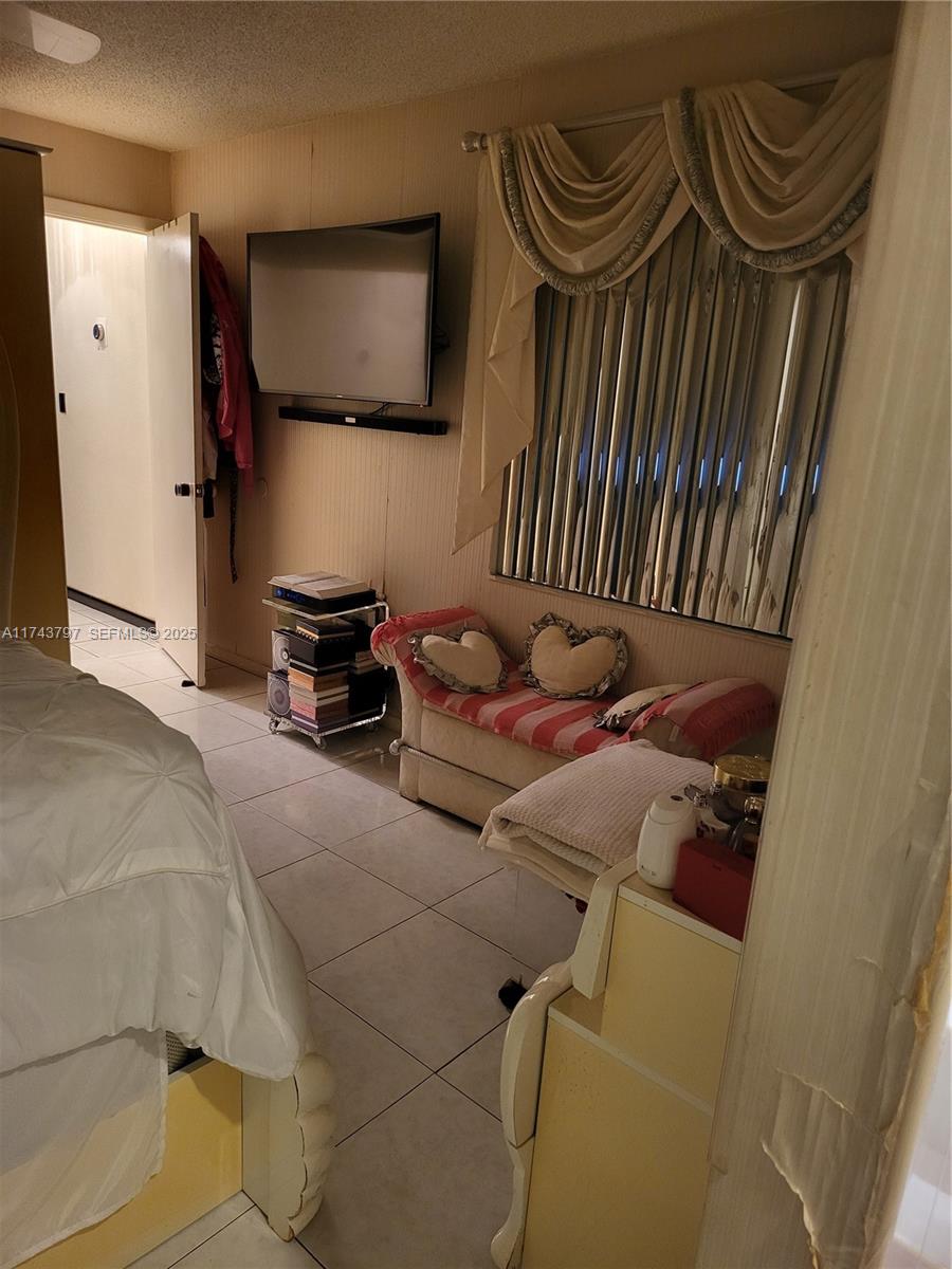 6771 Northwest 199th Terrace Hialeah, FL 33015 - Photo 24 of 42 a bedroom with a bed and a mirror