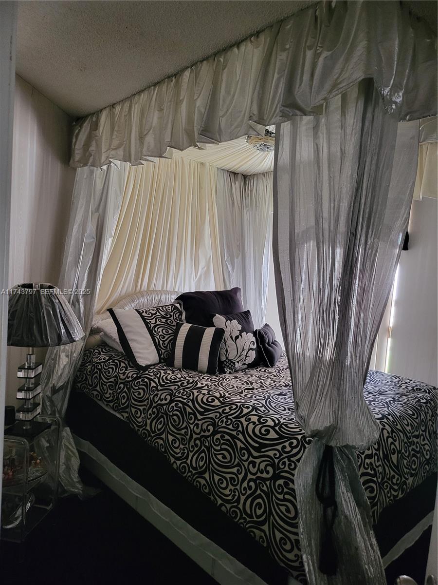 6771 Northwest 199th Terrace Hialeah, FL 33015 - Photo 26 of 42 a bedroom with a bed and a window