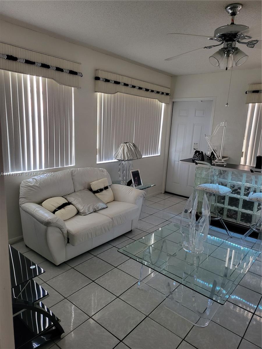 6771 Northwest 199th Terrace Hialeah, FL 33015 - Photo 36 of 42 a living room with furniture and a flat screen tv