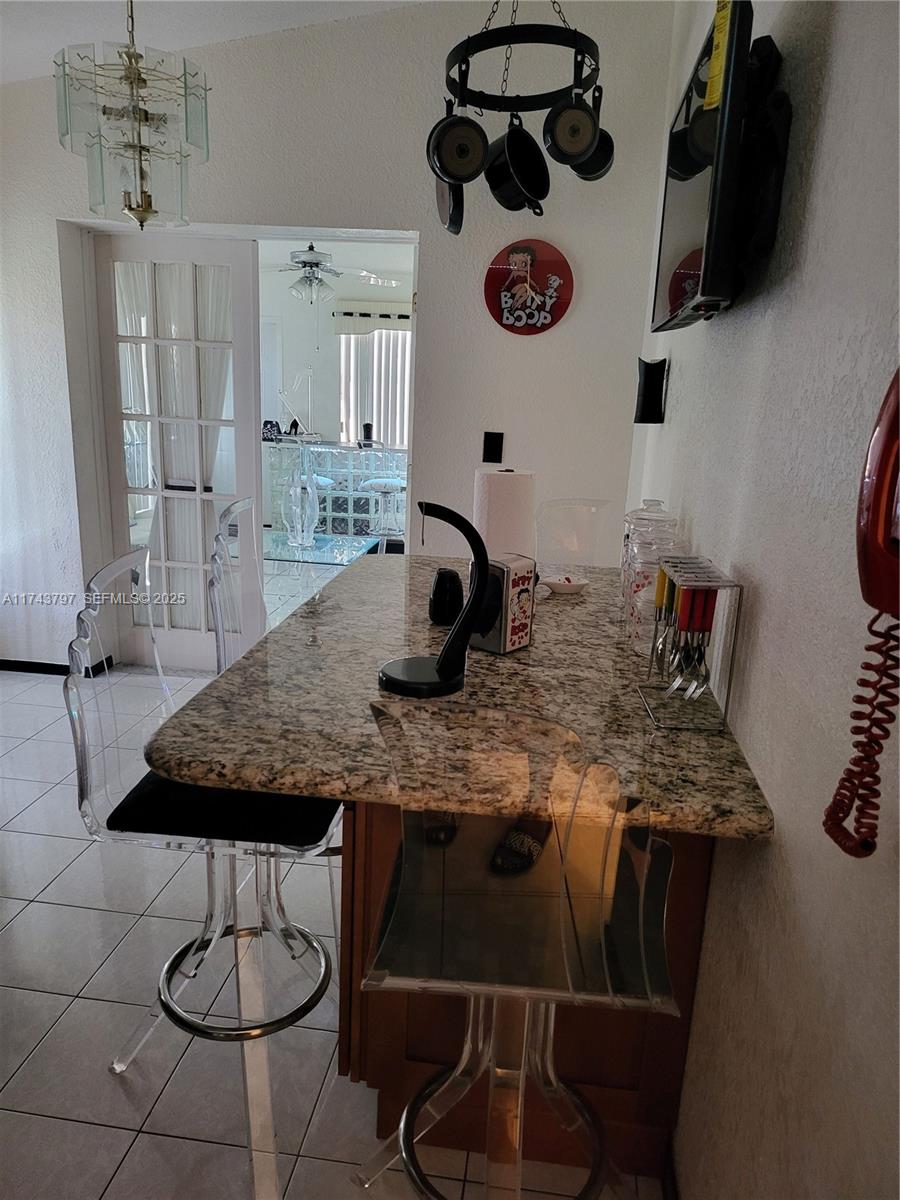 6771 Northwest 199th Terrace Hialeah, FL 33015 - Photo 39 of 42 a dining table with chairs and cabinets