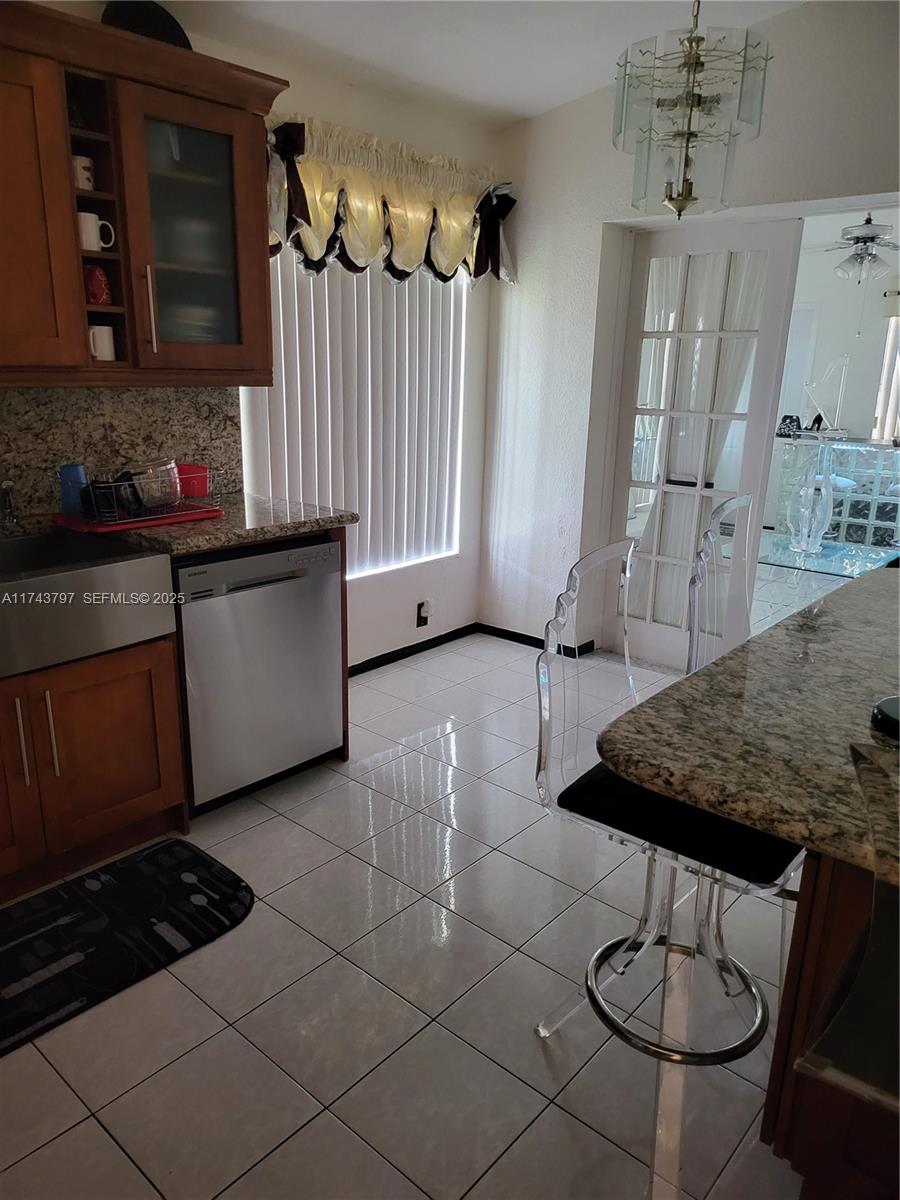 6771 Northwest 199th Terrace Hialeah, FL 33015 - Photo 40 of 42 a kitchen with stainless steel appliances granite countertop a sink and cabinets