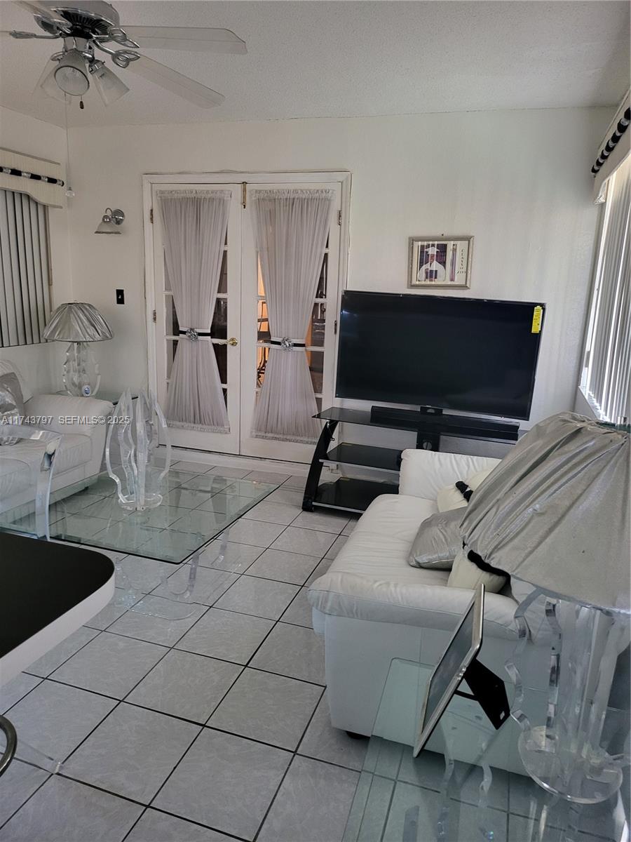 6771 Northwest 199th Terrace Hialeah, FL 33015 - Photo 41 of 42 a living room with furniture and a flat screen tv