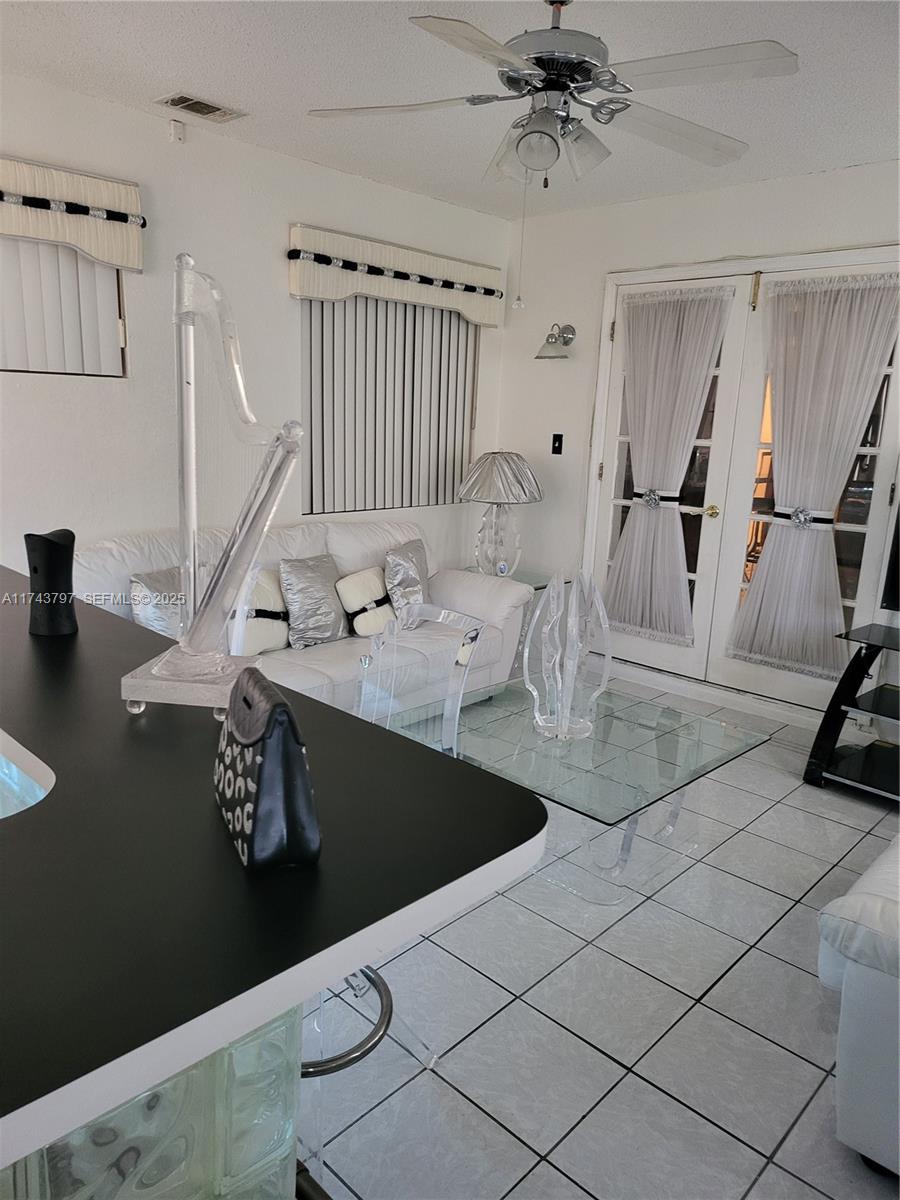 6771 Northwest 199th Terrace Hialeah, FL 33015 - Photo 5 of 42 a living room with furniture and a flat screen tv