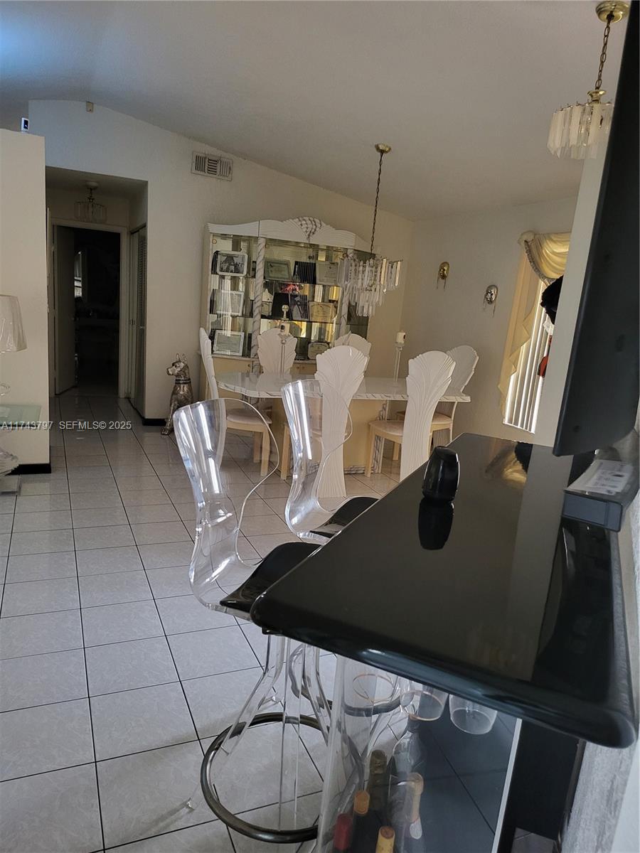 6771 Northwest 199th Terrace Hialeah, FL 33015 - Photo 7 of 42 a view of a dining room with furniture