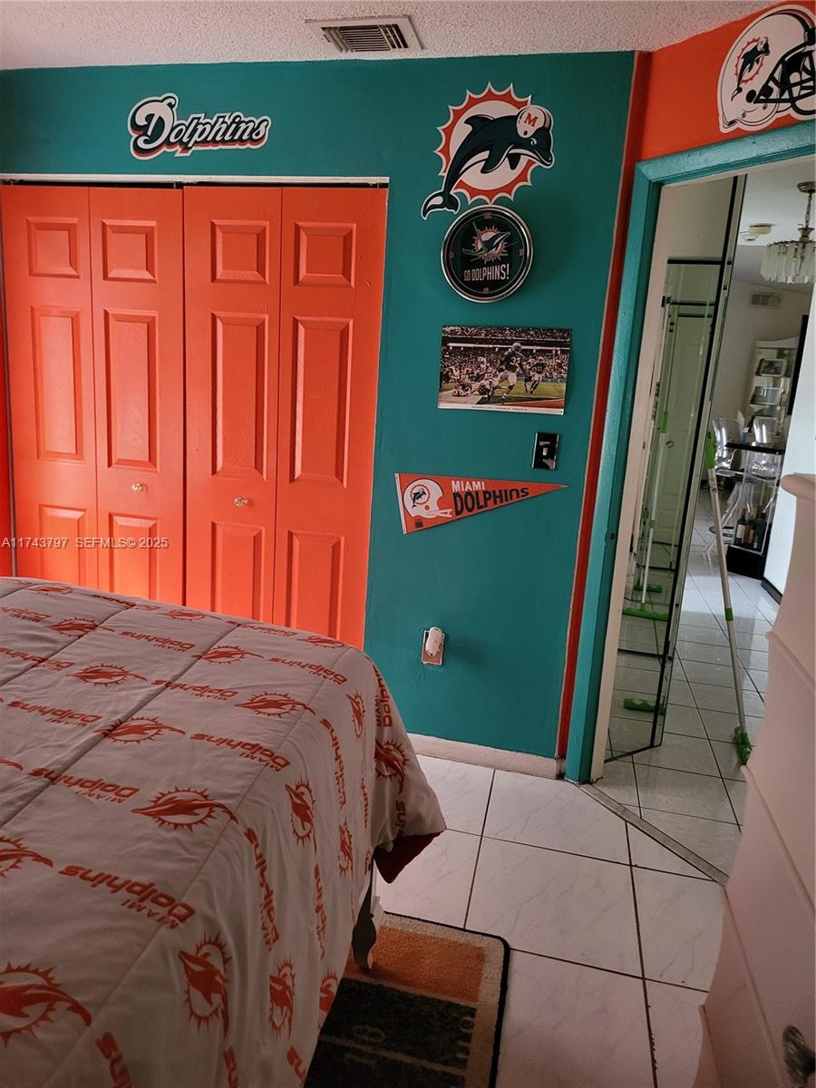 6771 Northwest 199th Terrace Hialeah, FL 33015 - Photo 8 of 42 a bed sitting in a bedroom next to a window