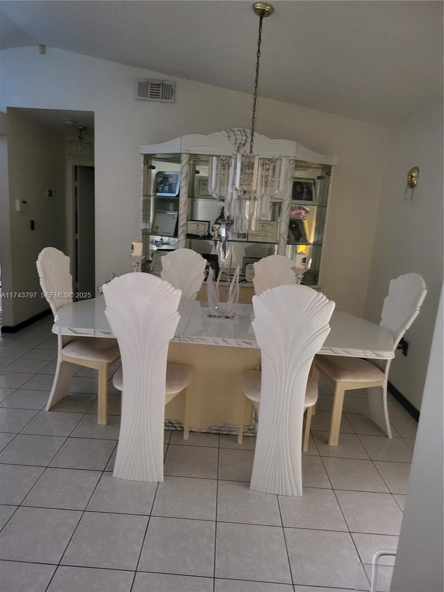 6771 Northwest 199th Terrace Hialeah, FL 33015 - Photo 9 of 42 a view of a dining room with furniture