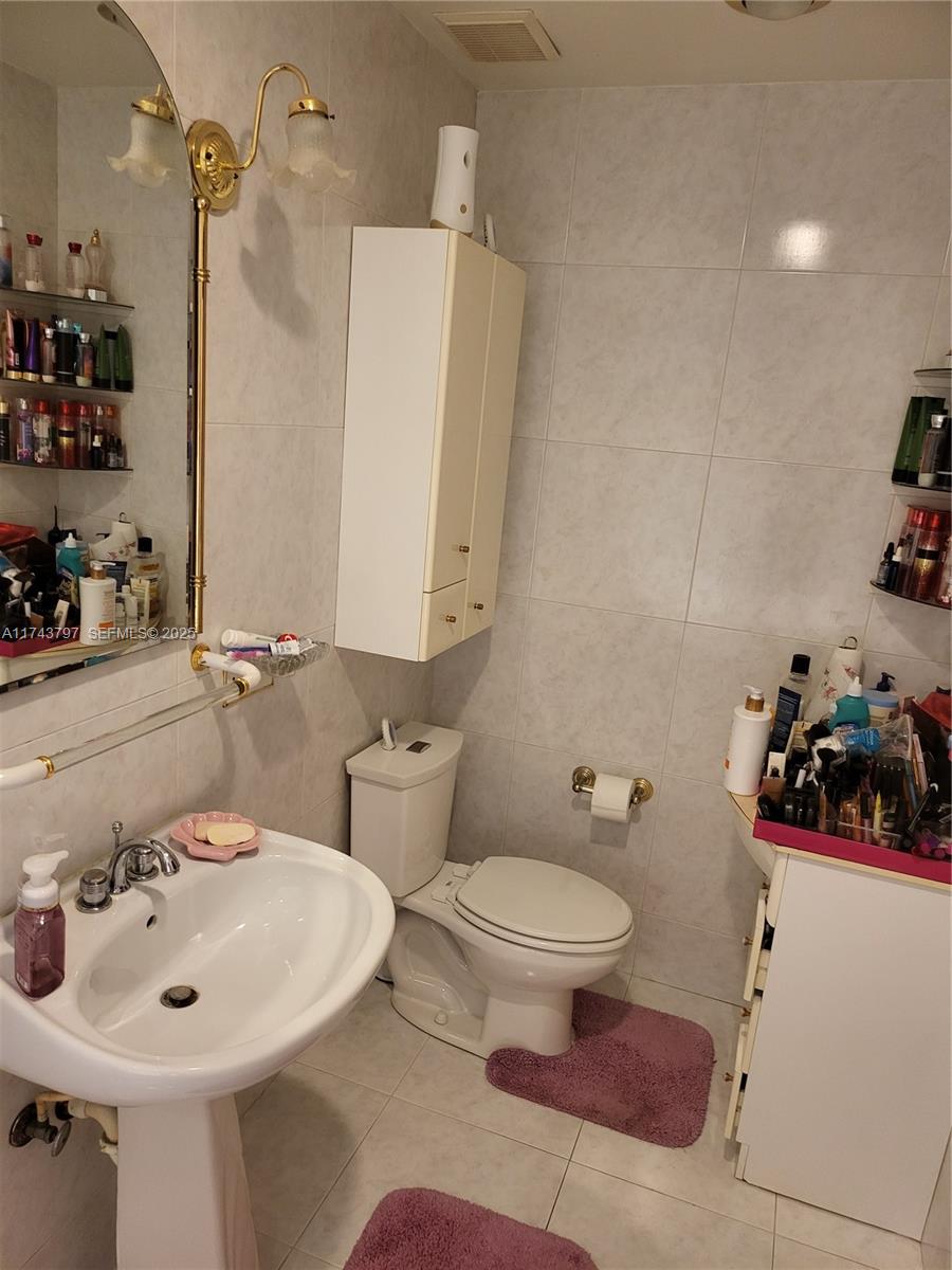 6771 Northwest 199th Terrace Hialeah, FL 33015 - Photo 10 of 42 a bathroom with a sink toilet and shower