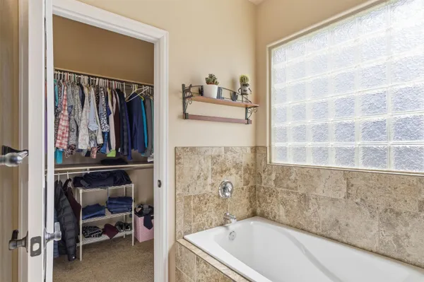 a bathroom with a tub and a window