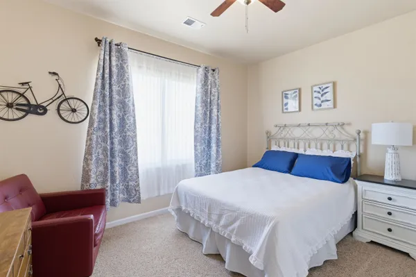 a bedroom with a bed and a couch