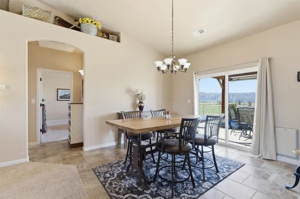 a view of a dining room with furniture and chandelier