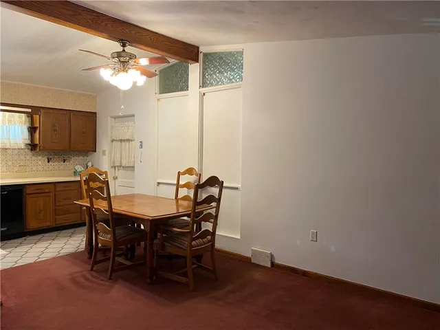 a view of a dining room with furniture and a chandelier fan