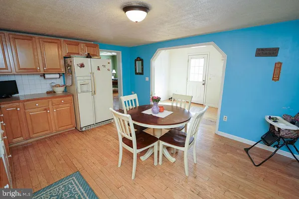 a dining room with furniture and wooden floor