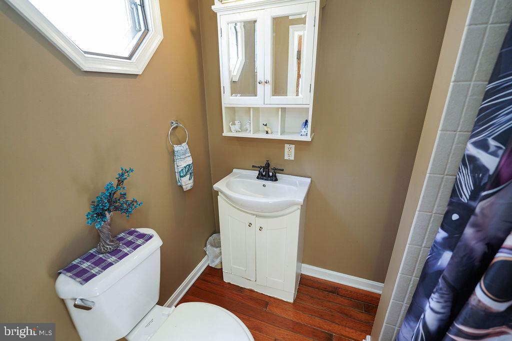 212 Main Street Preston, MD 21655 - Photo 17 of 40 a bathroom with a sink toilet and a mirror