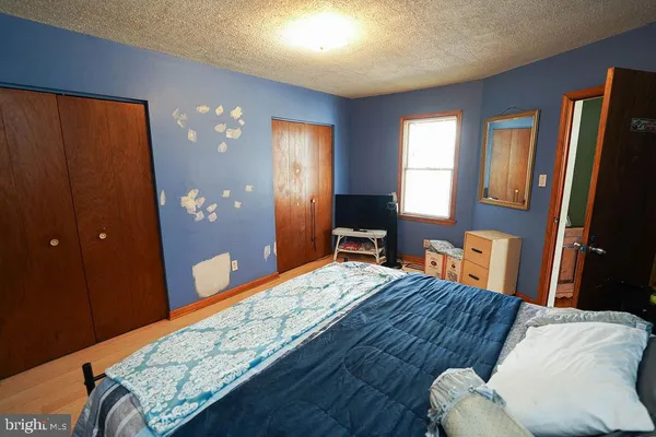 a bedroom with a bed and wooden furniture