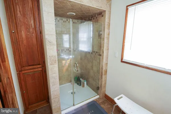 a bathroom with a tub and shower