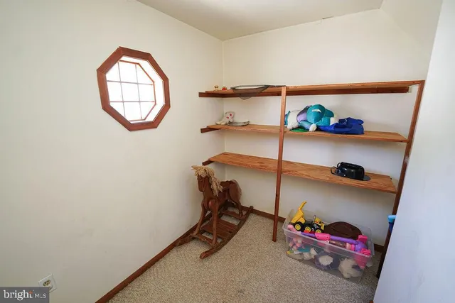 a bedroom with bed and a window