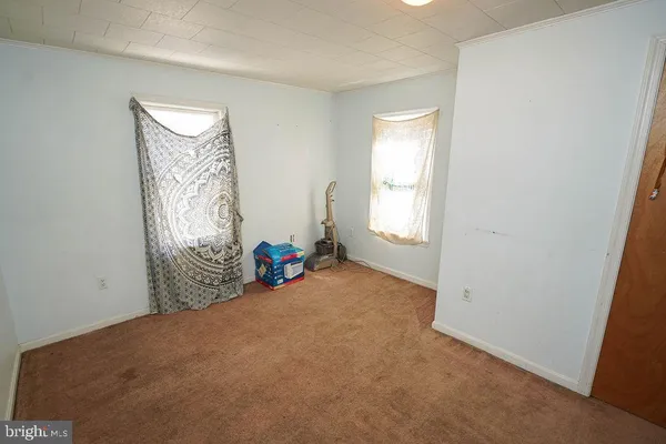 a view of a livingroom with furniture and a window
