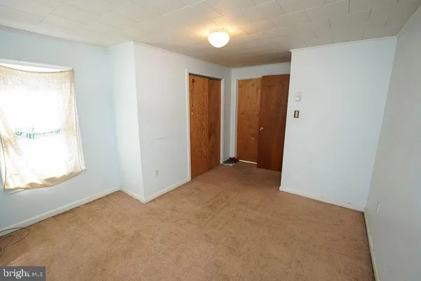 a view of an empty room and a window