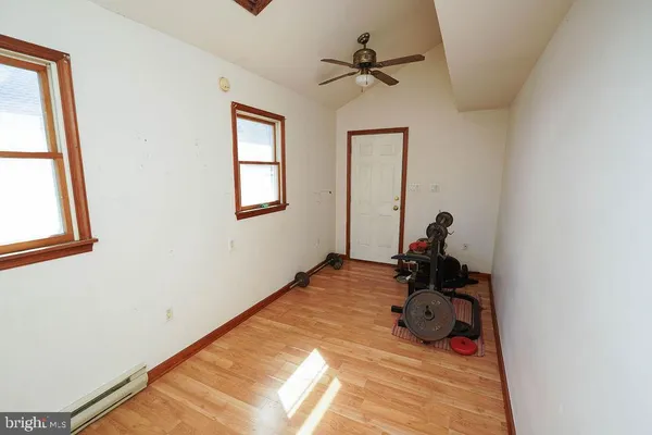 a room with wooden floor and furniture