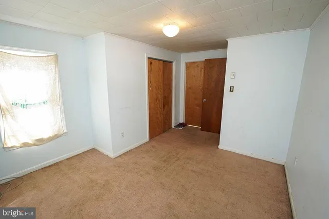 a bed room with a bed and a window