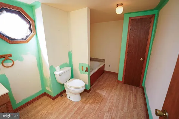 a bathroom with a toilet a sink and a mirror