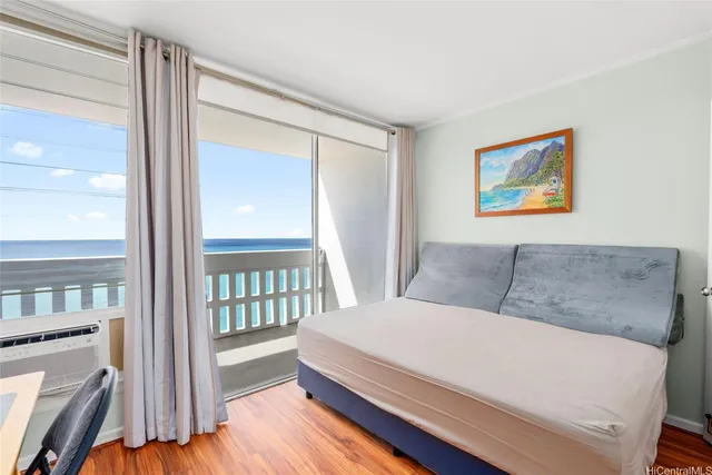 a living room with a bed furniture and a large window