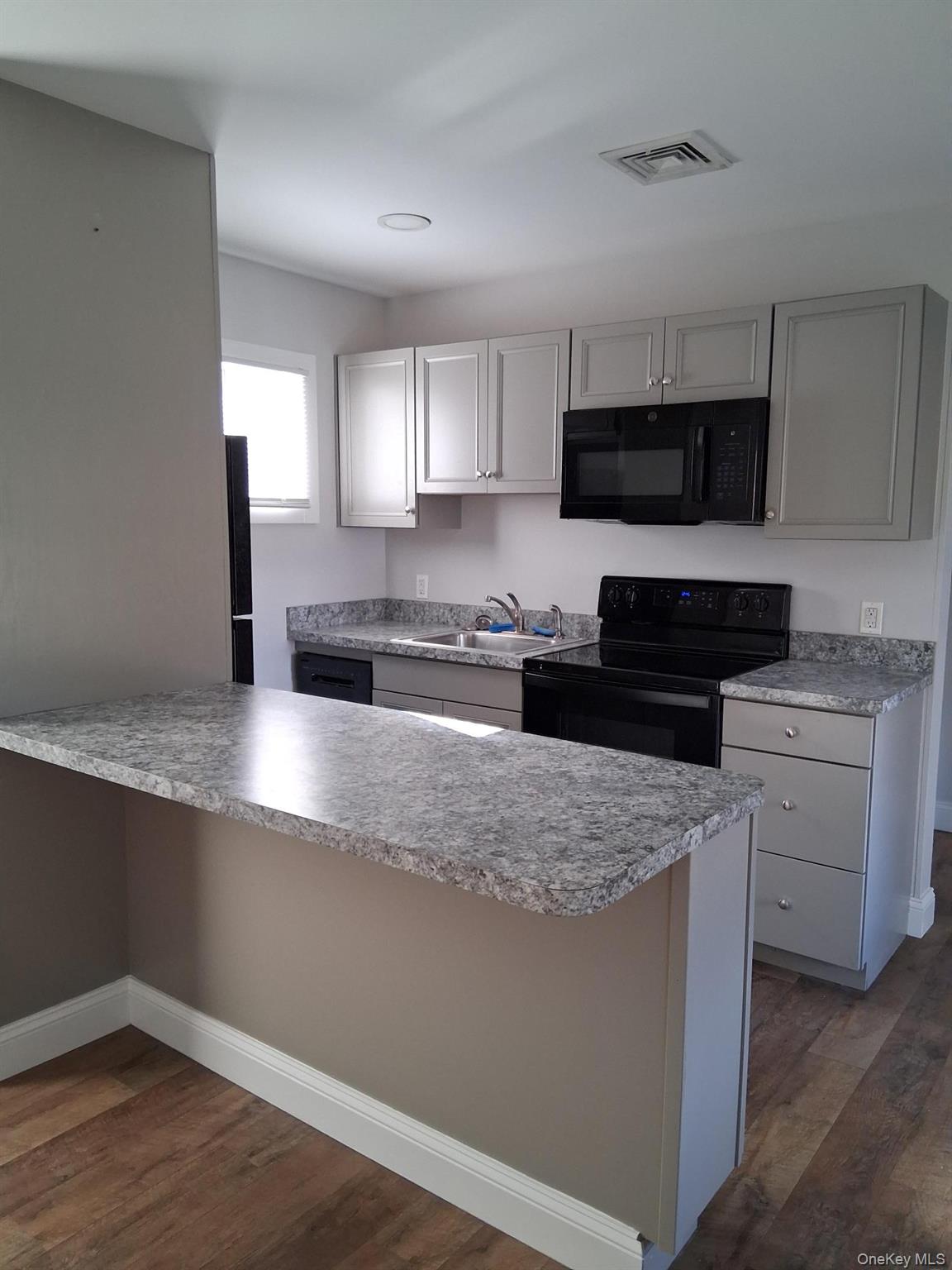 218 Highway 199 Red Hook, NY 12571 - Photo 2 of 7 a kitchen with stainless steel appliances granite countertop a stove a sink and a microwave