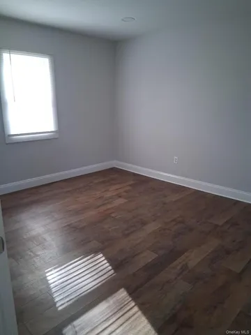a view of wooden floor in an empty room