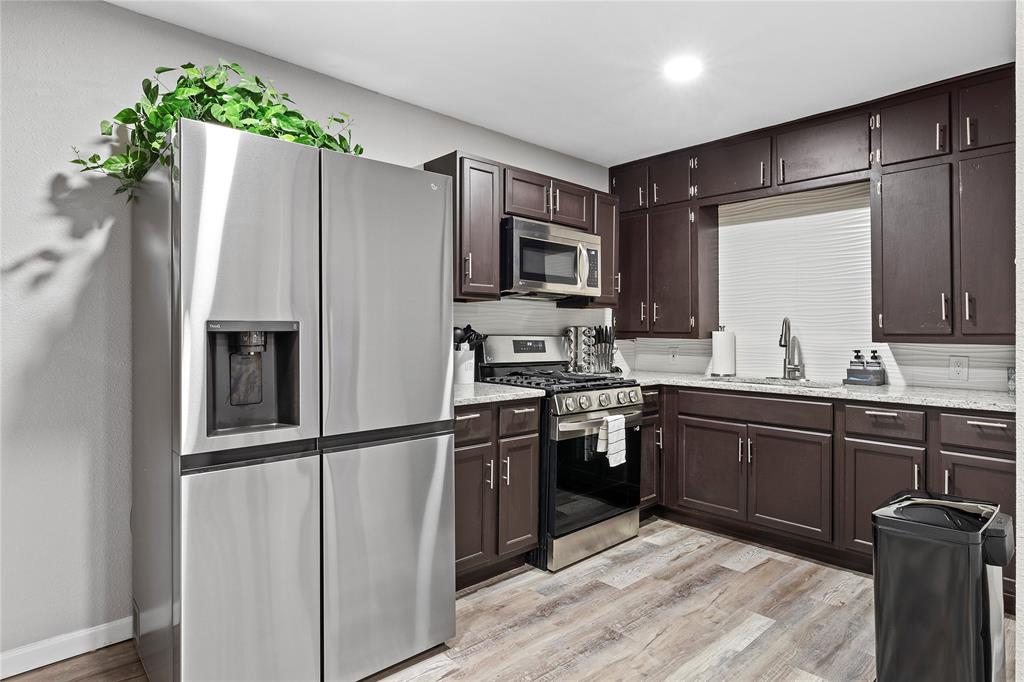 1900 North 6th Street Waco, TX 76708 - Photo 6 of 23 a kitchen with stainless steel appliances granite countertop a refrigerator and a sink