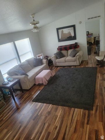 2180 North 1950th Street West Helper, UT 84526 - Photo 3 of 11 Living room with dark wood-style floors and a textured ceiling
