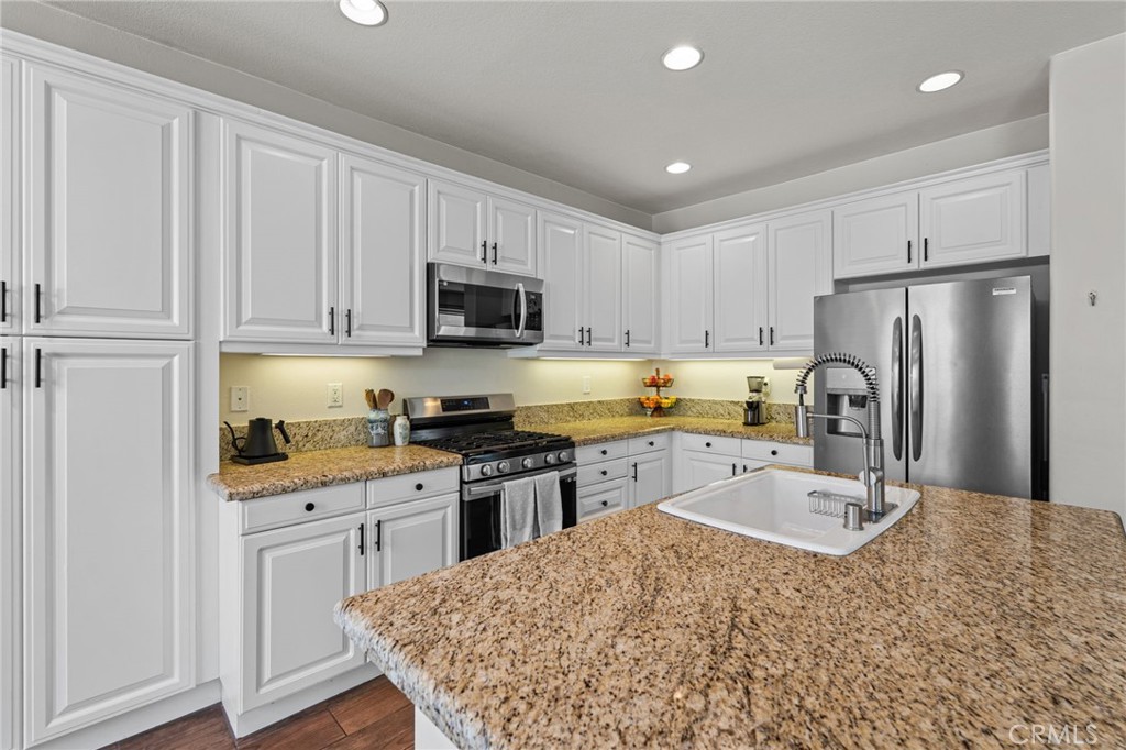 28356 Santa Rosa Lane Saugus, CA 91350 - Photo 6 of 50 a kitchen with stainless steel appliances granite countertop a refrigerator sink and cabinets