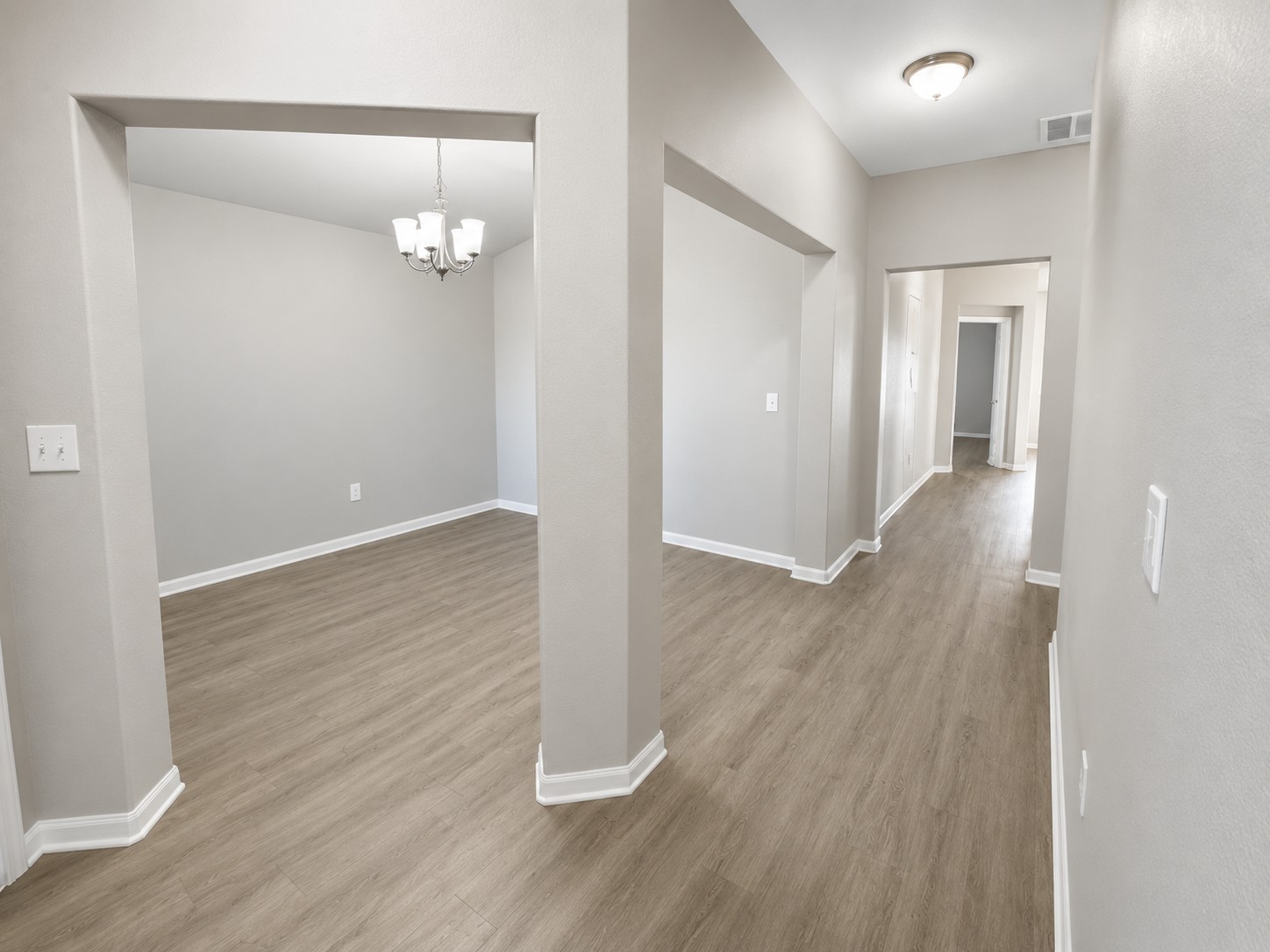 228 Avalanche Avenue Georgetown, TX 78626 - Photo 2 of 16 wooden floor in an empty room with a mirror