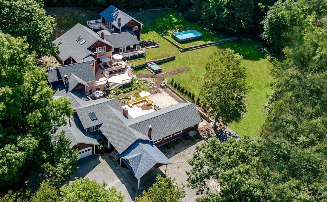 an aerial view of a house with garden space and street view
