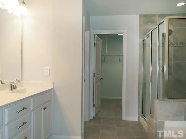 a spacious bathroom with a shower and a sink