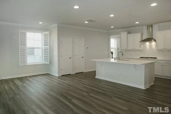 a view of kitchen with granite countertop cabinets and wooden floor