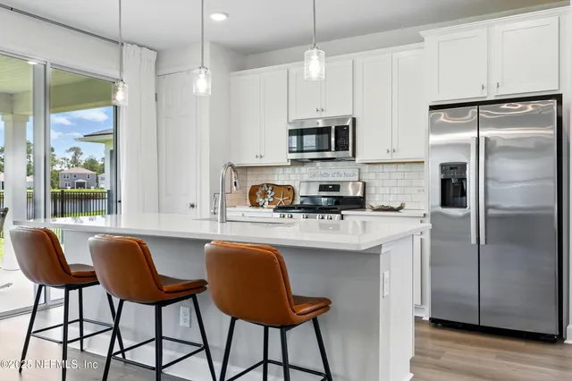 a kitchen with stainless steel appliances a stove a microwave and cabinets