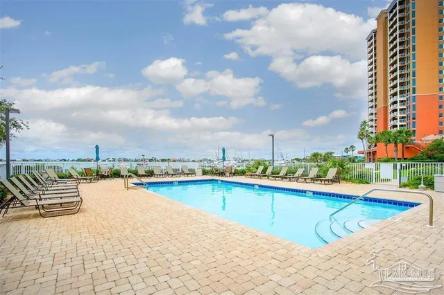 swimming pool view with a lake view