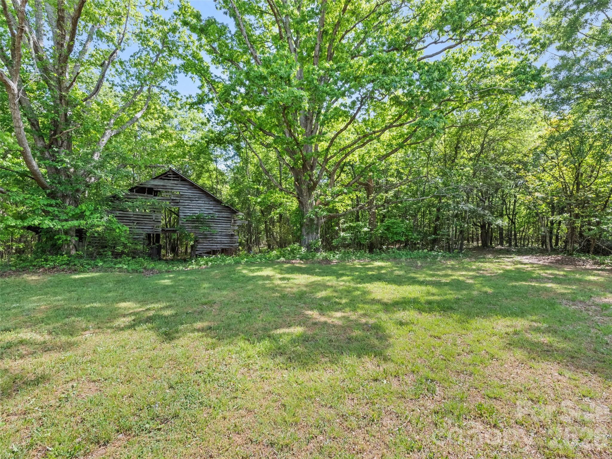 311 Soco Gap Road Ellenboro, NC 28040 - Photo 16 of 24 a backyard of a house with lots of green space