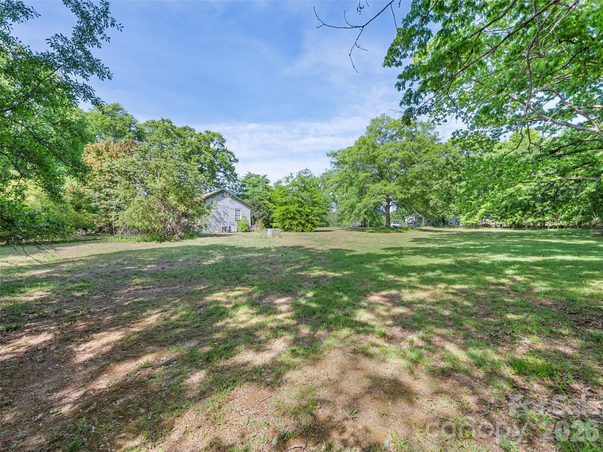 311 Soco Gap Road Ellenboro, NC 28040 - Photo 2 of 24 a view of a green field with trees in the background