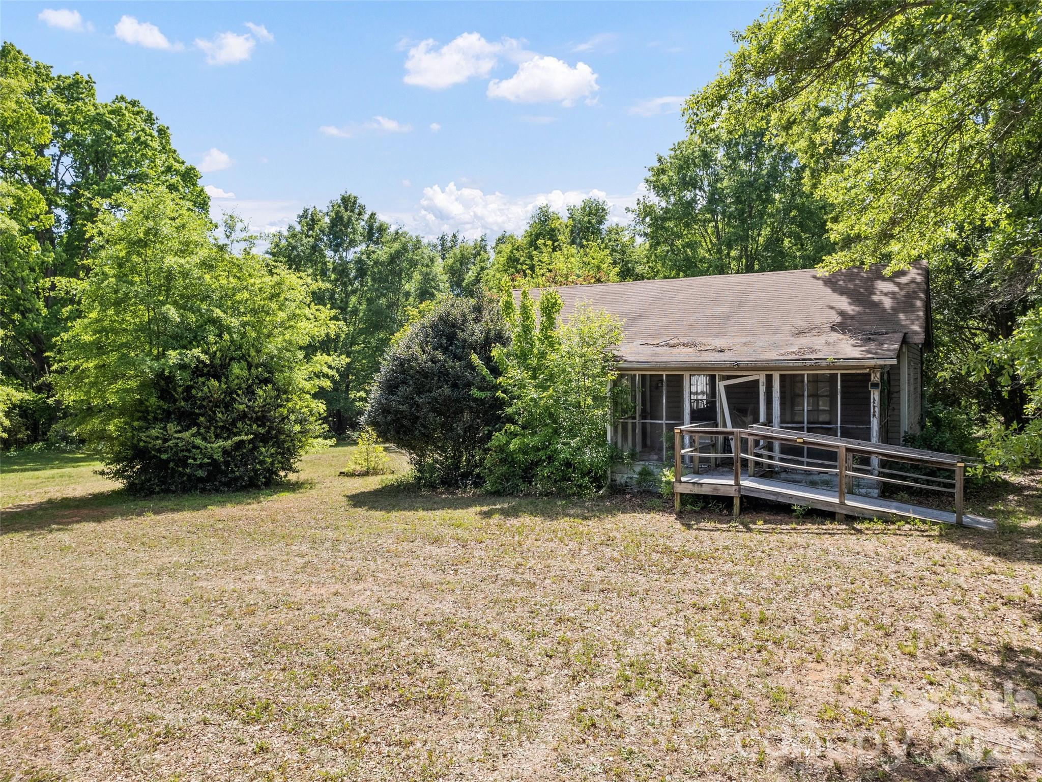 311 Soco Gap Road Ellenboro, NC 28040 - Photo 8 of 24 a view of backyard with table and chairs and potted plants