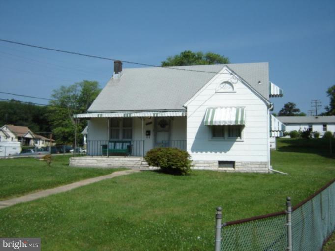 8004 Philadelphia Road Rosedale, MD 21237 - Photo 1 of 2 a front view of a house with a garden