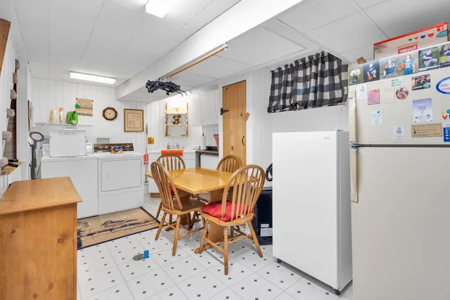 a view of a dining room with furniture chandelier and window