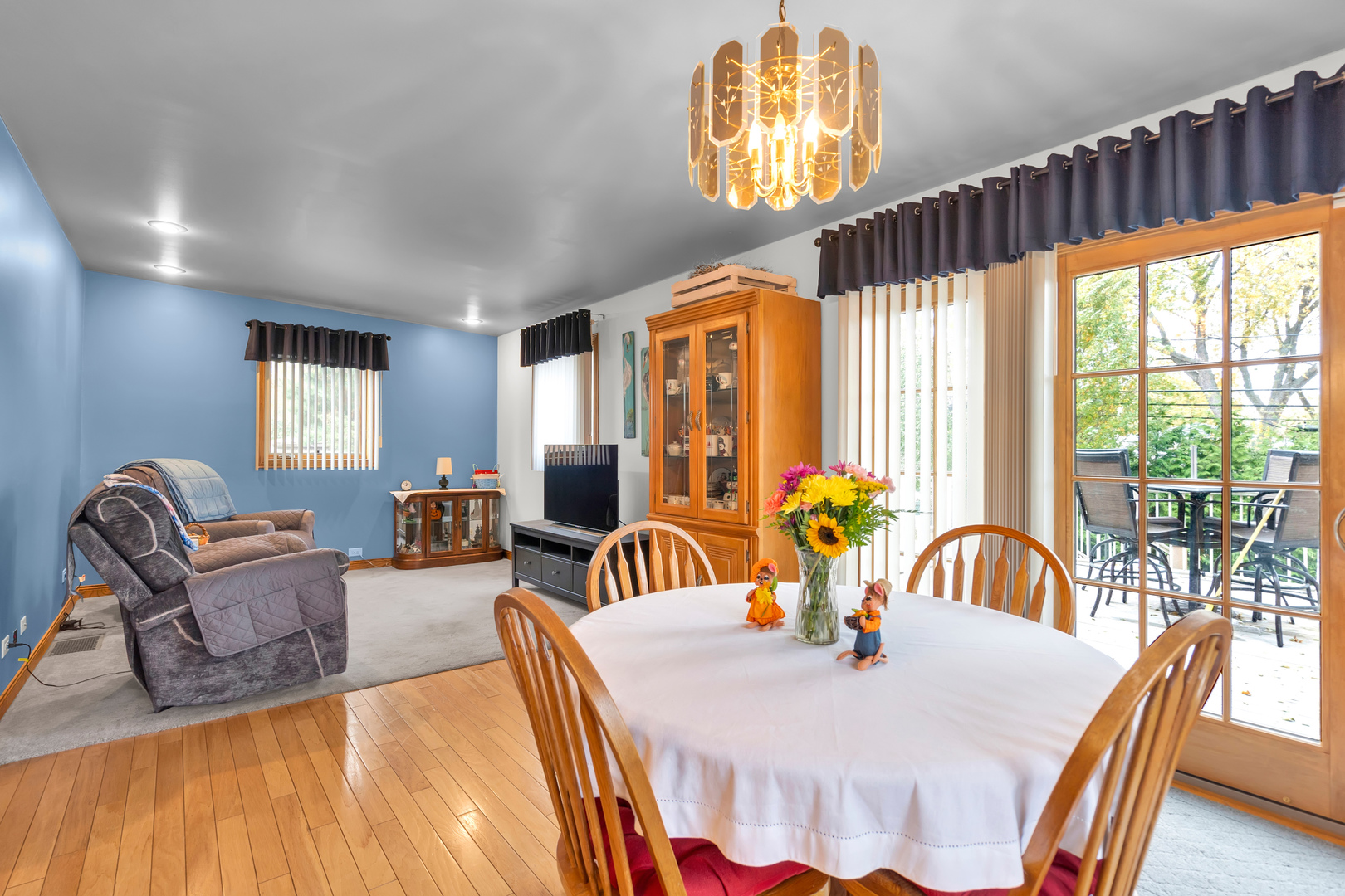 6528 Ridge Drive Chicago Ridge, IL 60415 - Photo 7 of 33 a dining room with furniture a chandelier and wooden floor