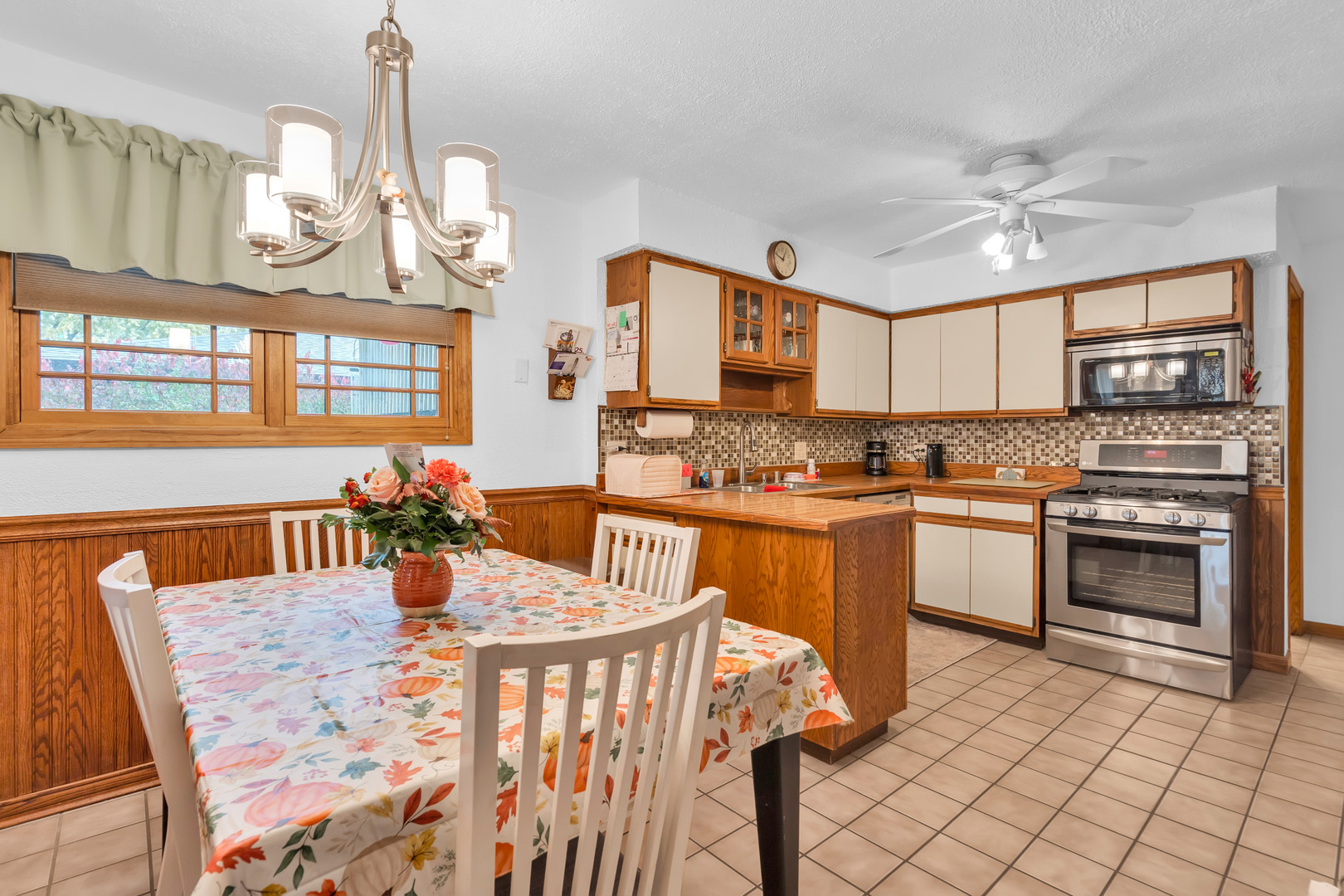 6528 Ridge Drive Chicago Ridge, IL 60415 - Photo 8 of 33 a kitchen with stainless steel appliances granite countertop a sink dishwasher a stove a dining table and chairs with wooden floor