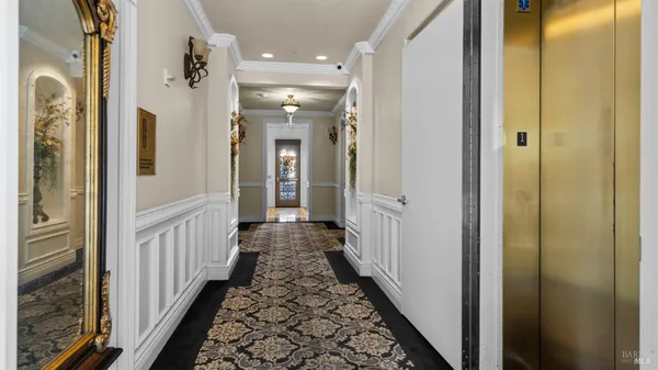 a hallway with couches and wooden floor
