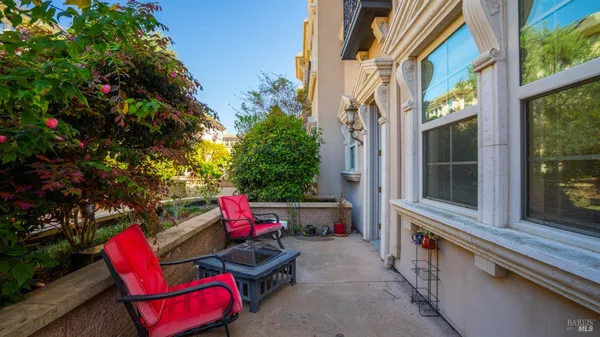 a view of a hallway with wooden floor and closet